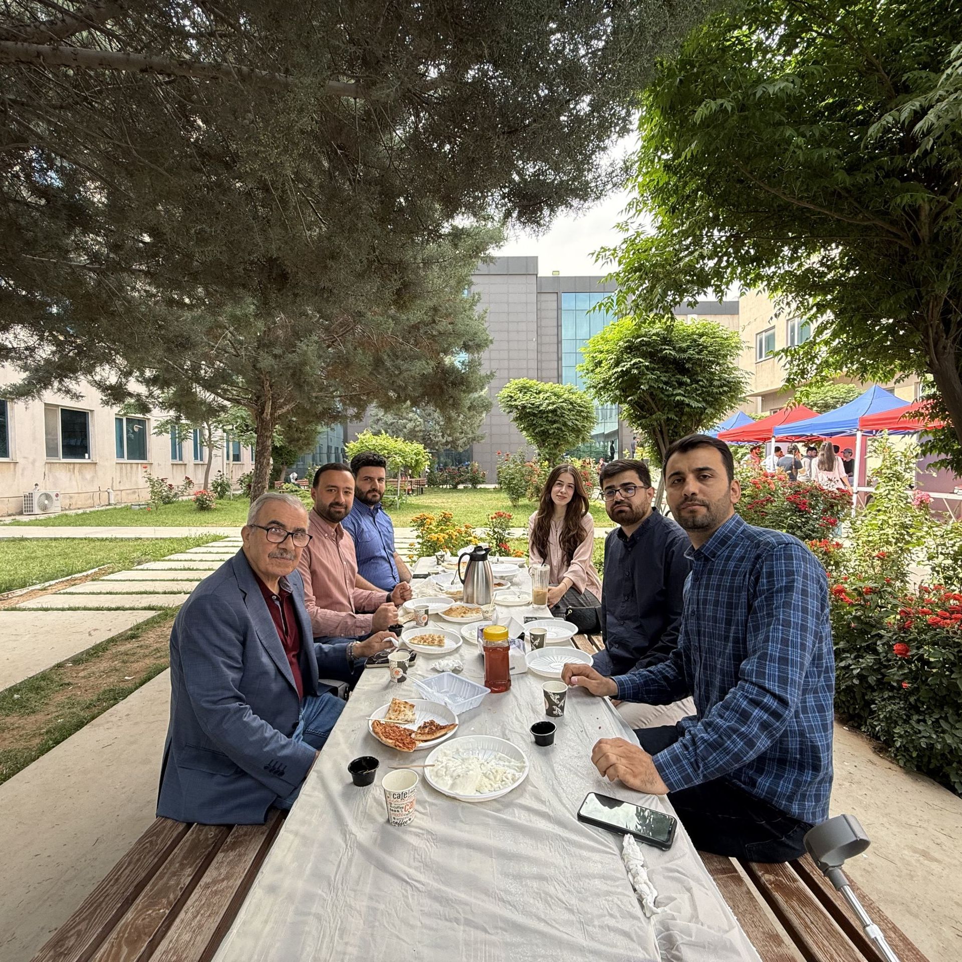 Staff gathering at TIU in university gardens