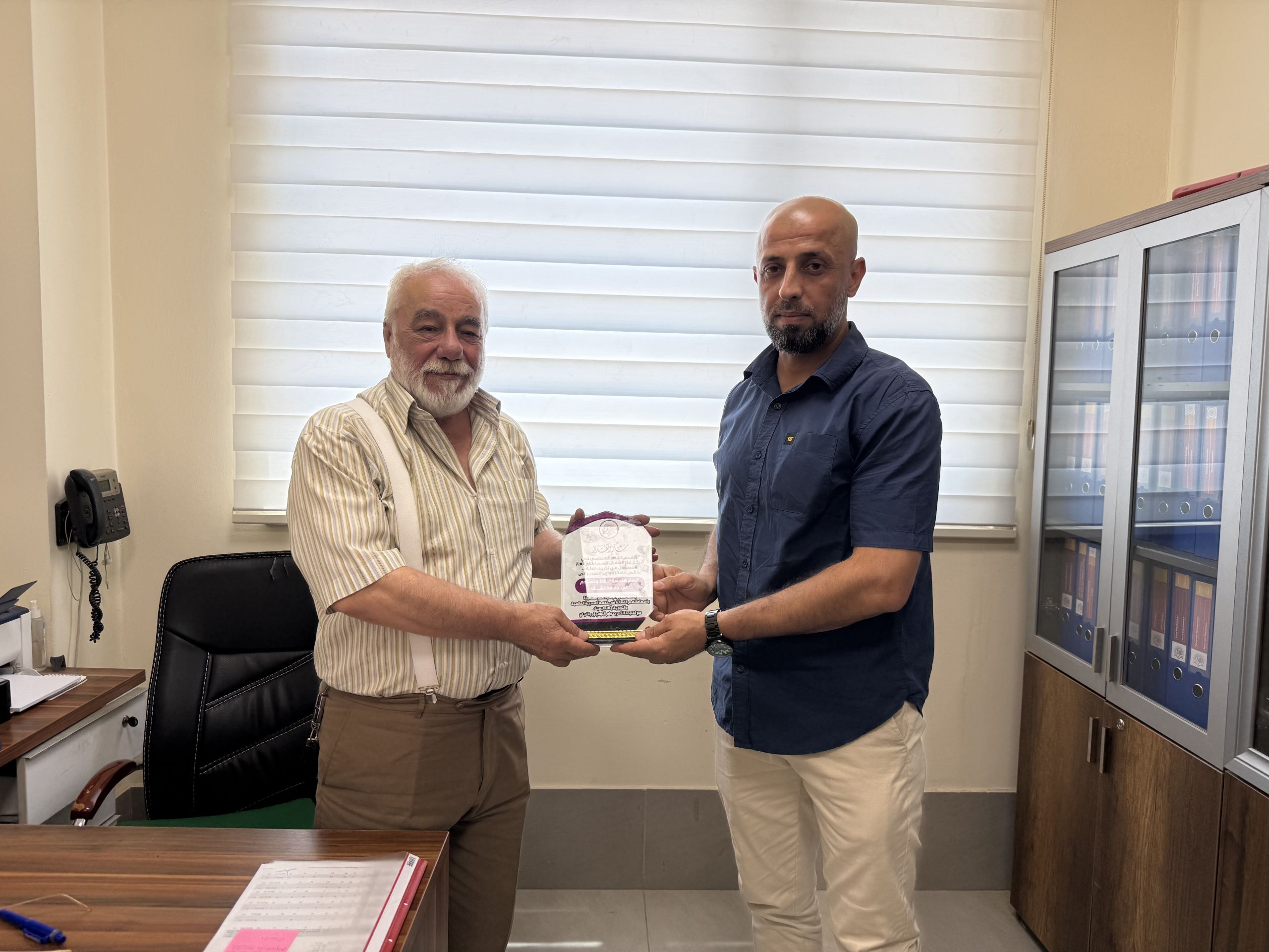 North Gas Company engineers presenting an appreciation plaque to the department.