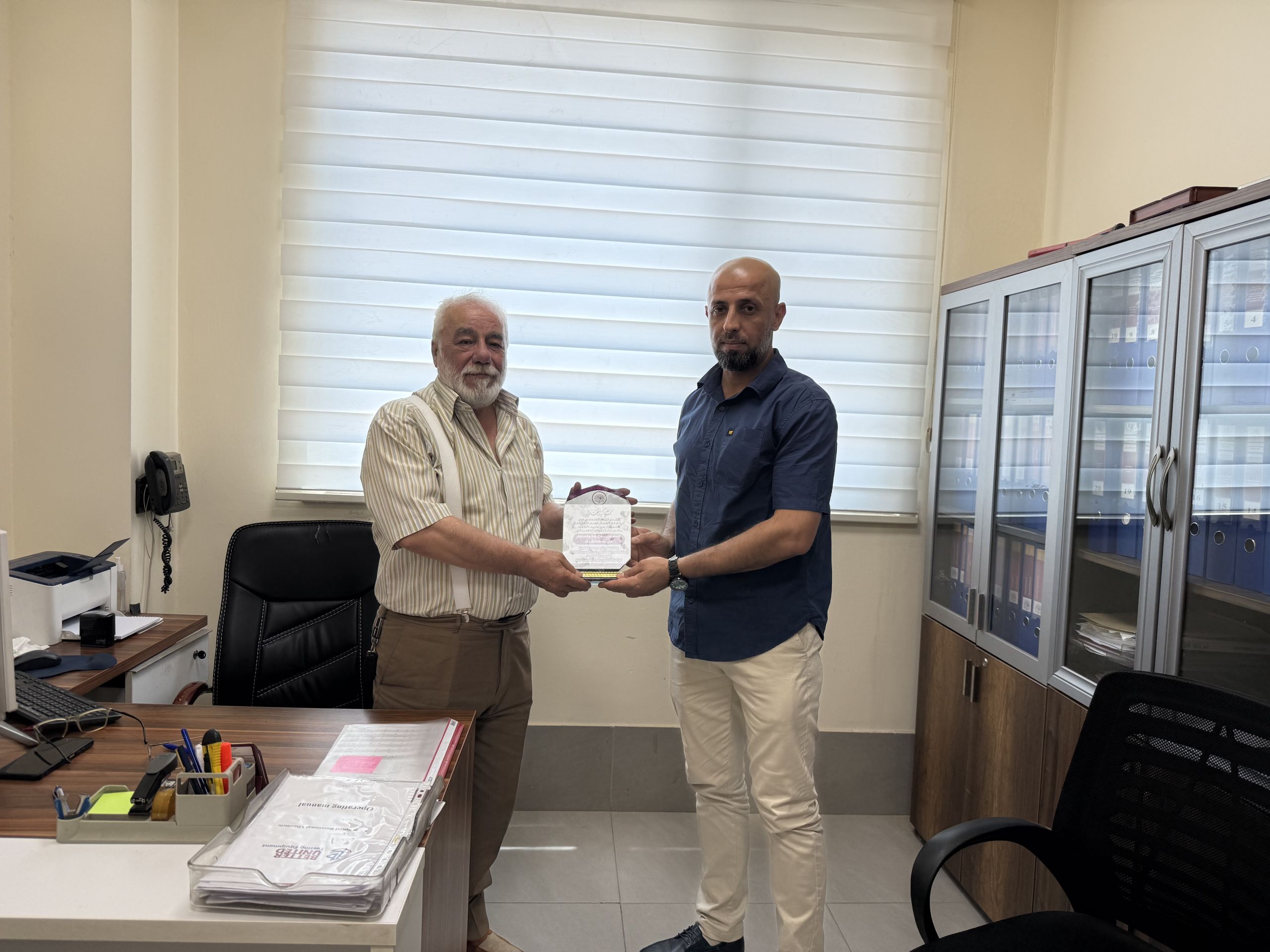 North Gas Company engineers presenting an appreciation plaque to the department.